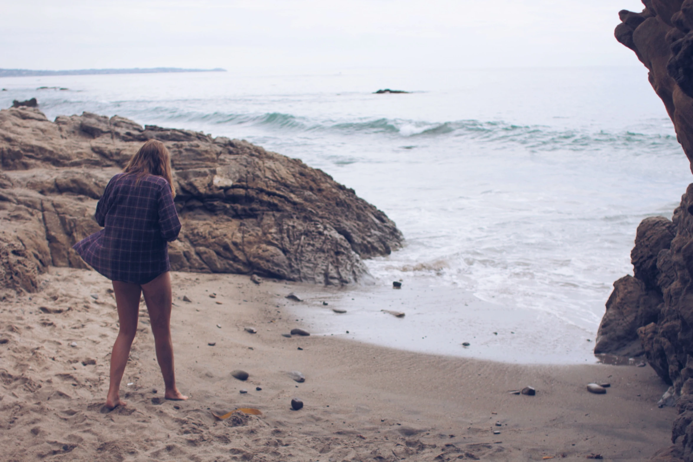 the young woman is looking out at the water