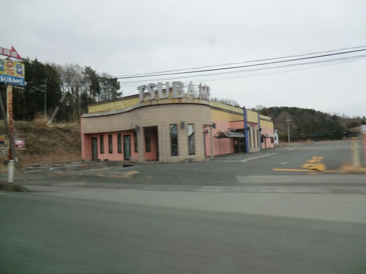 an old movie theater near the road in a town