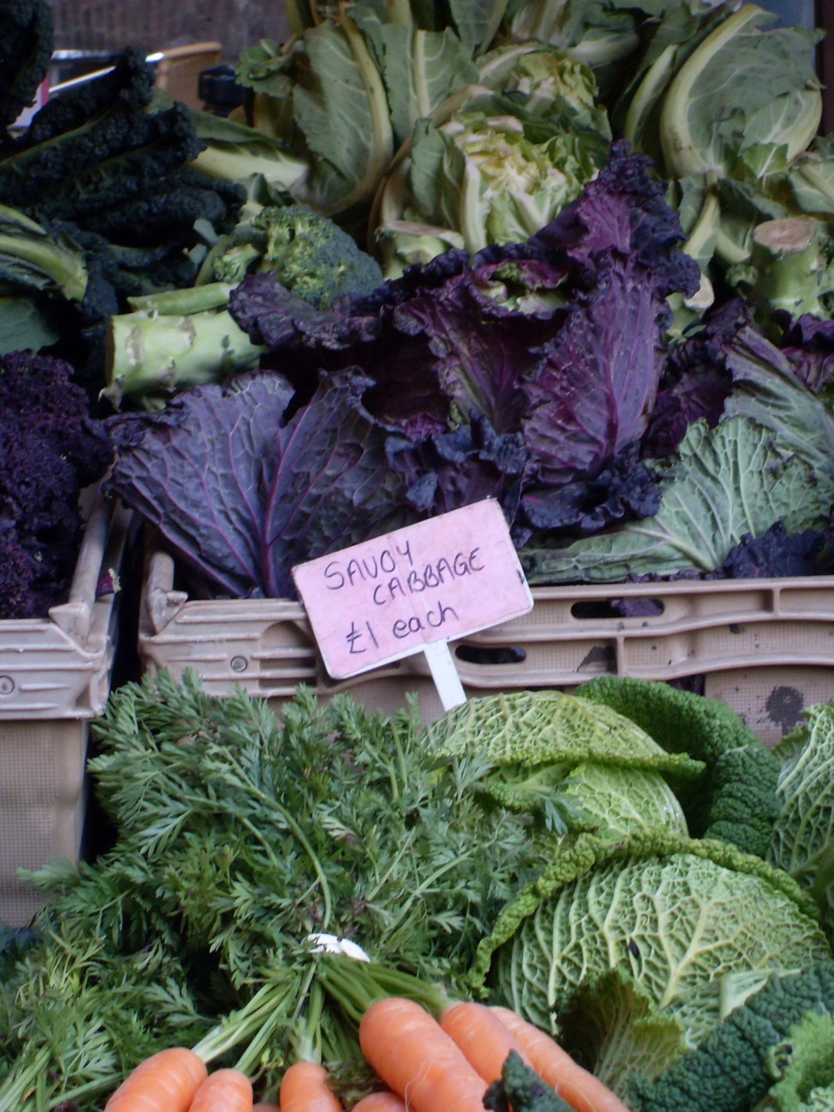 bunches of vegetables on display for sale at a market