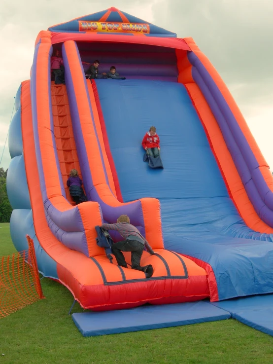 a inflatable water slide with a man laying on the side