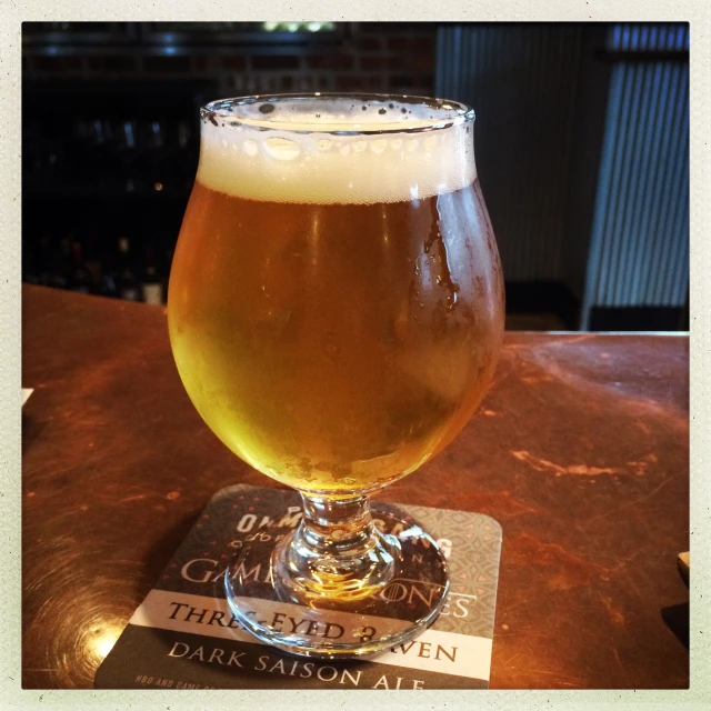 a beer glass sitting on top of a table