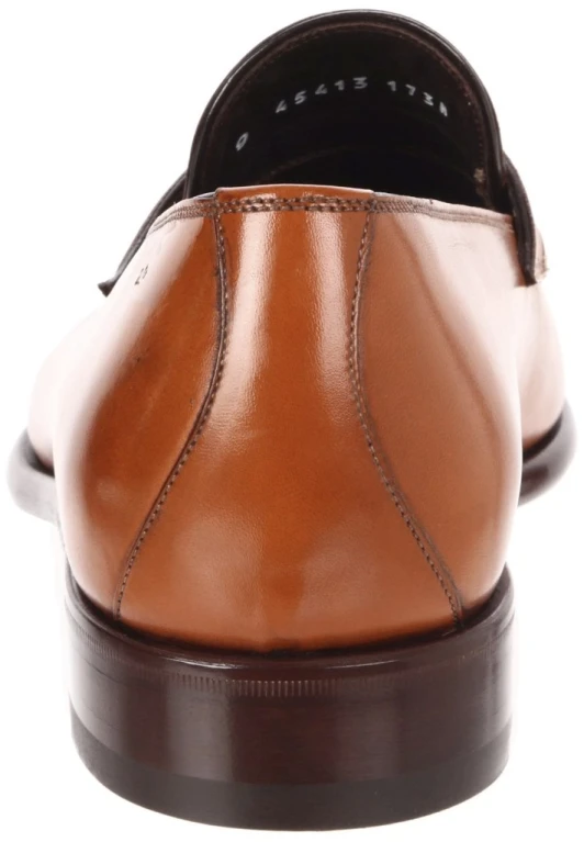 a tan dress shoe with black toe detailing