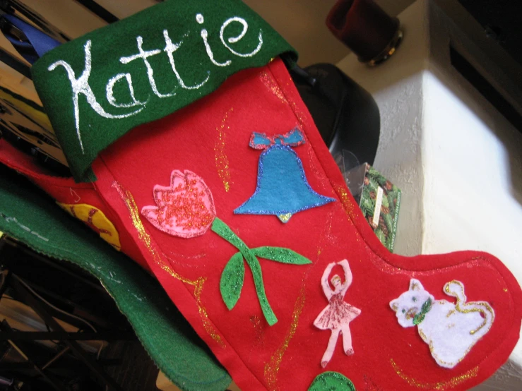 the stockings on a counter have animals embroidered on them