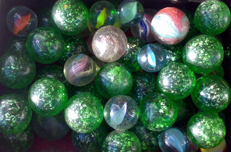 some colorful glass balls with a red background