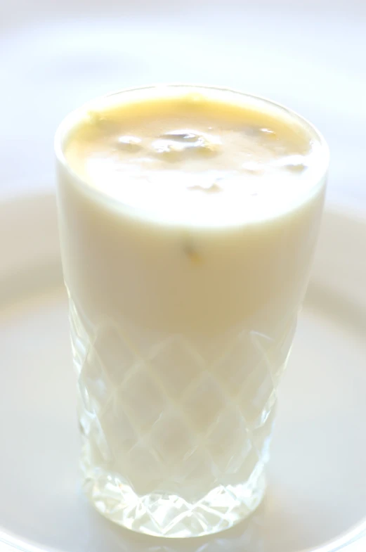 a glass sitting on top of a white plate