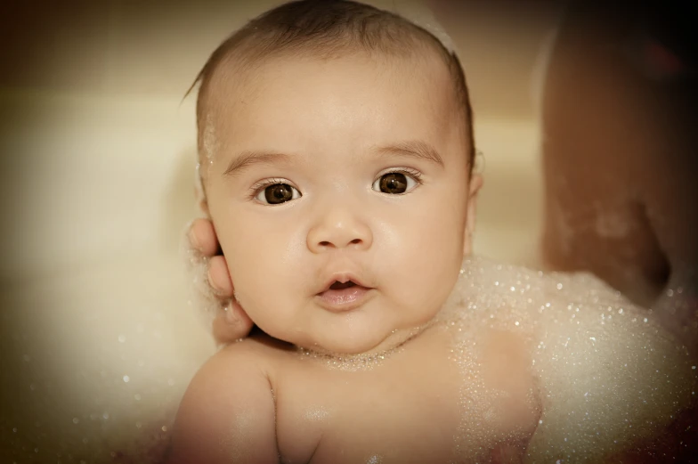 a baby that has water on its head