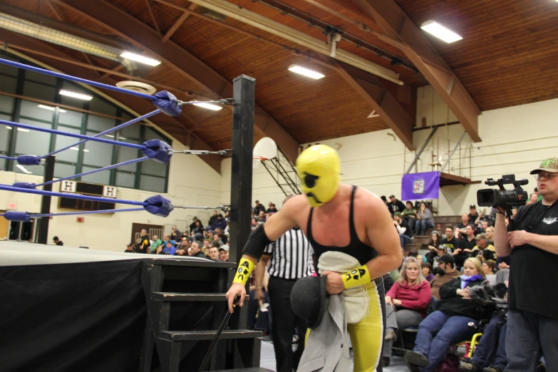 the wrestler wearing his yellow face paint on his face