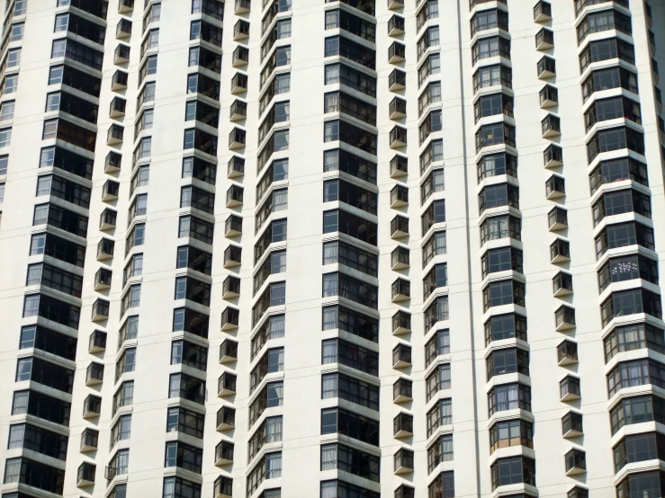 the top of a tall white building with many windows