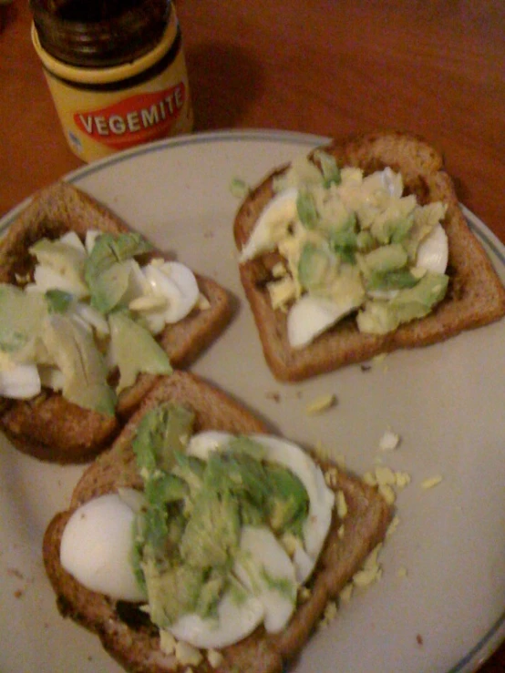 several slices of toast with avocado and sour cream