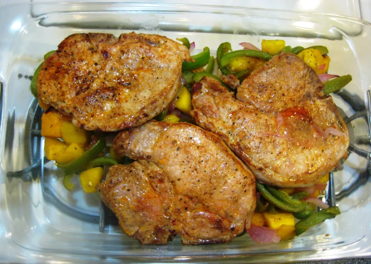 a tray holds several pieces of meat and vegetables