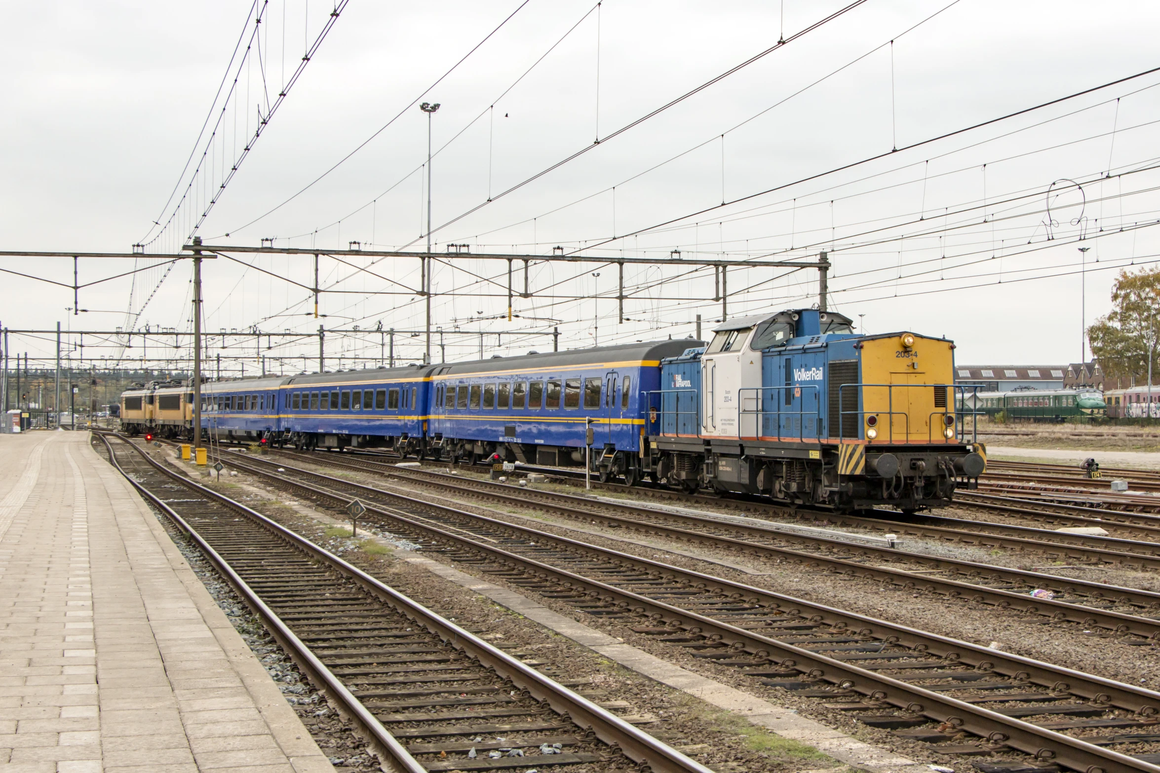 three trains are on the tracks near one another