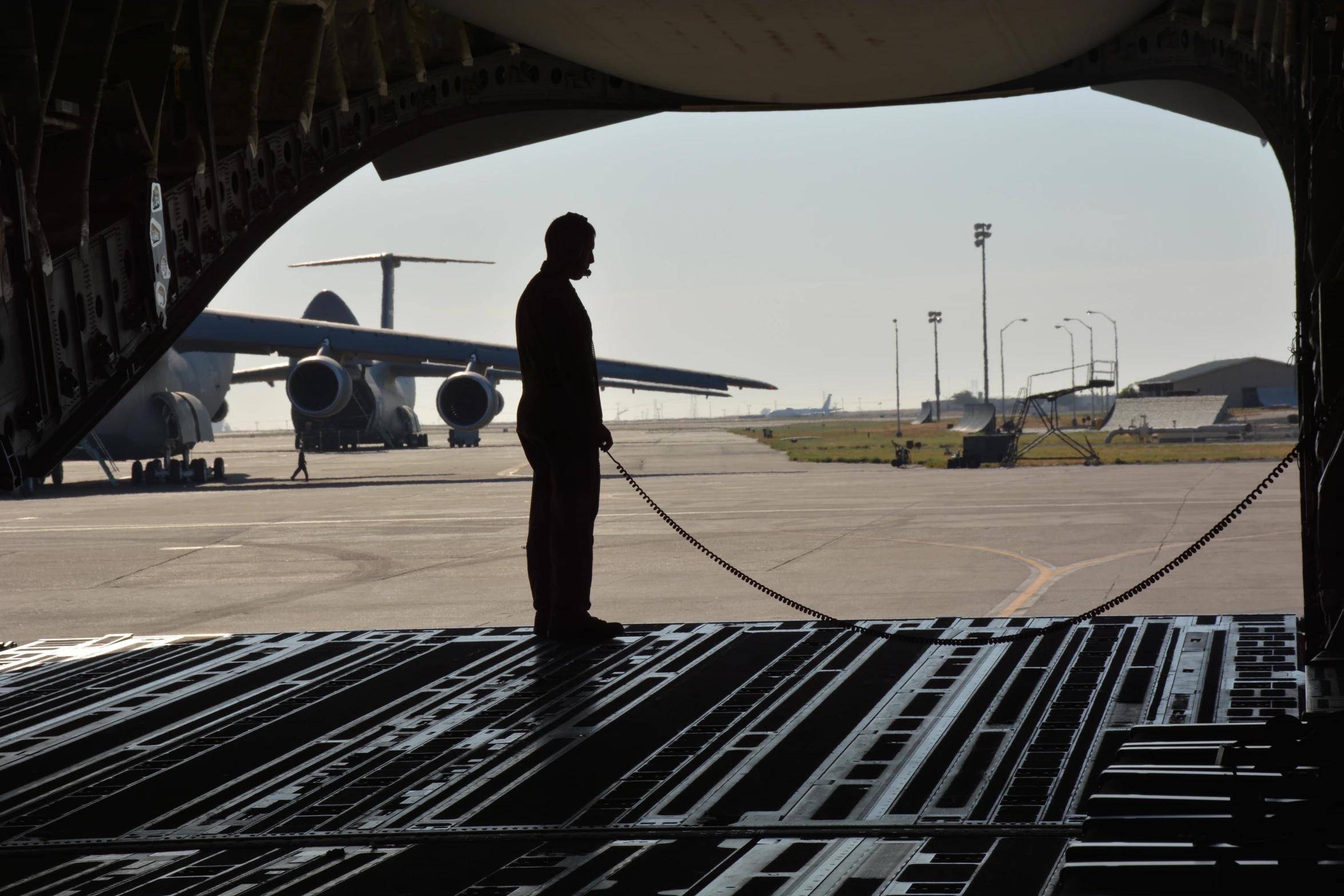 a man pulling a rope near an airplane