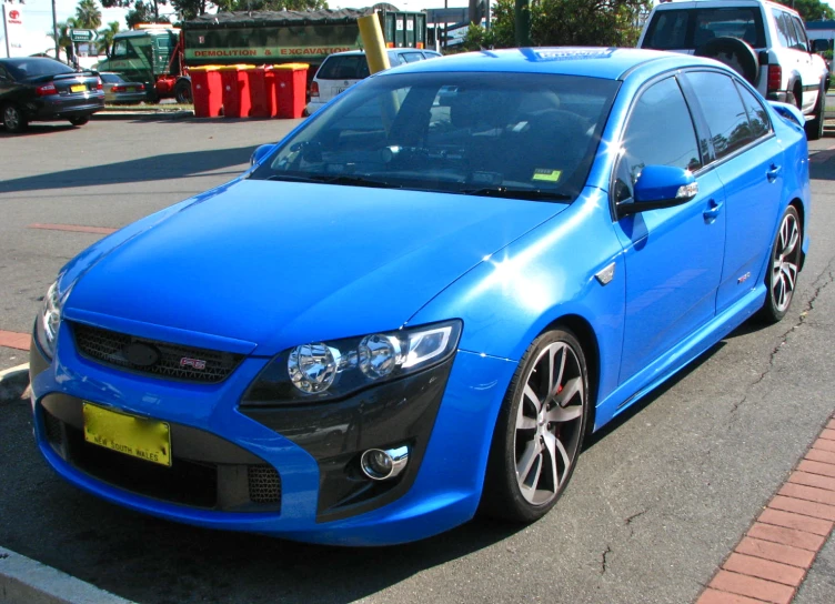 a blue car that is parked on the street