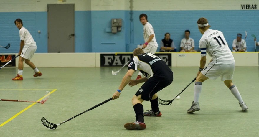 men playing hockey while a crowd watches from the sidelines