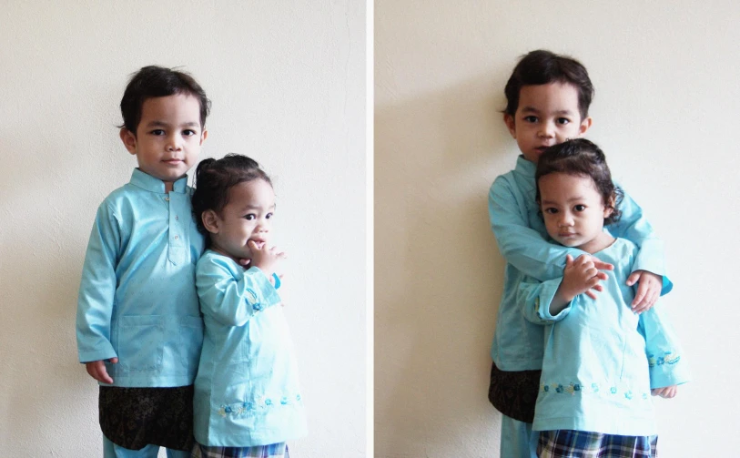 two little children hugging each other while they are posing