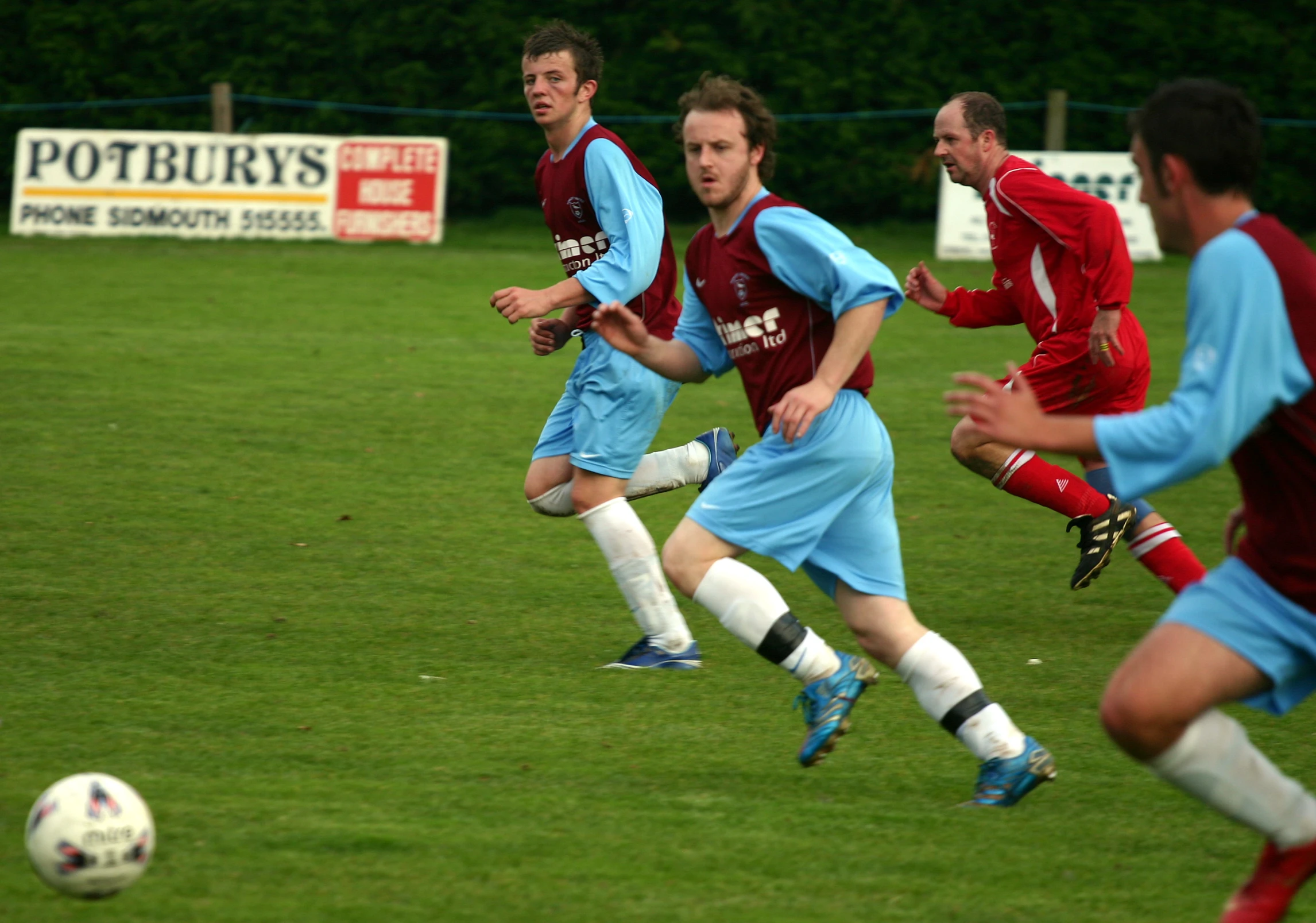 two teams of men are competing in a soccer game