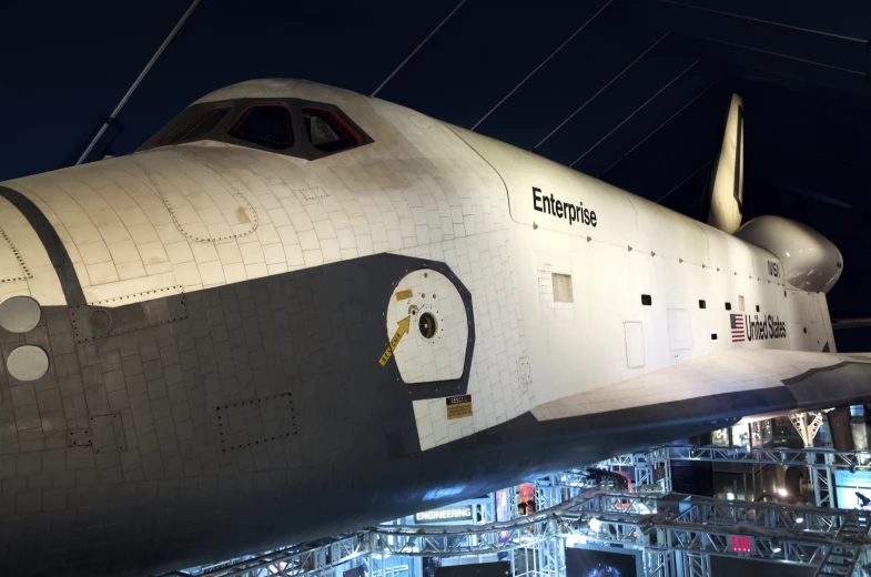 a space shuttle is displayed in the middle of an airport hangar