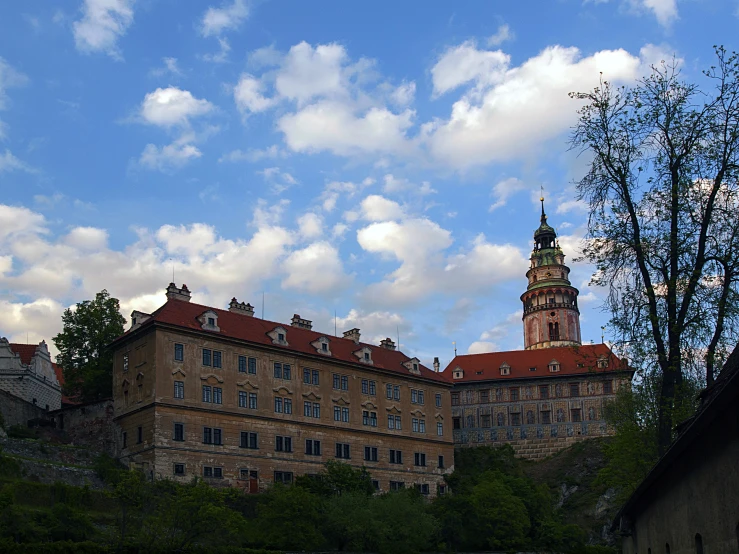 the old buildings are near some green trees