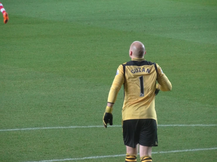 a soccer player walking onto the field