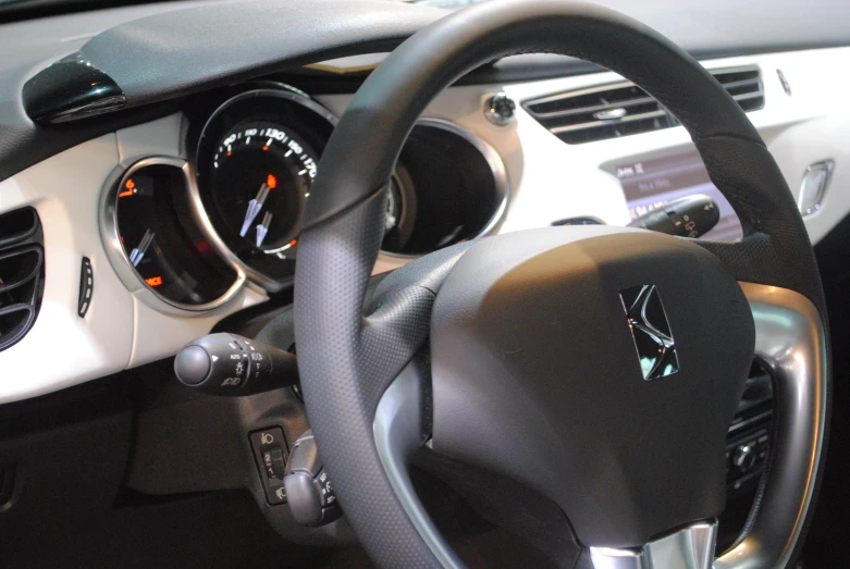 a car dashboard with a meter and steering wheel