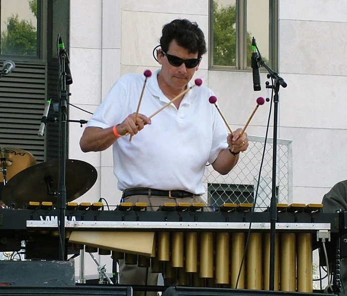 an image of a man playing the drum set