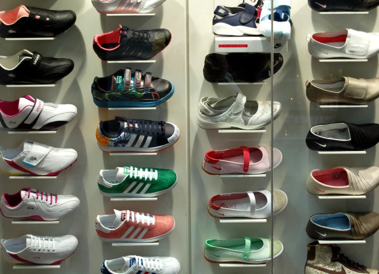 many pairs of shoes on shelves near each other
