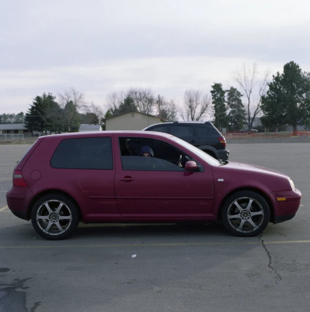 a car sits in a parking lot on the asphalt