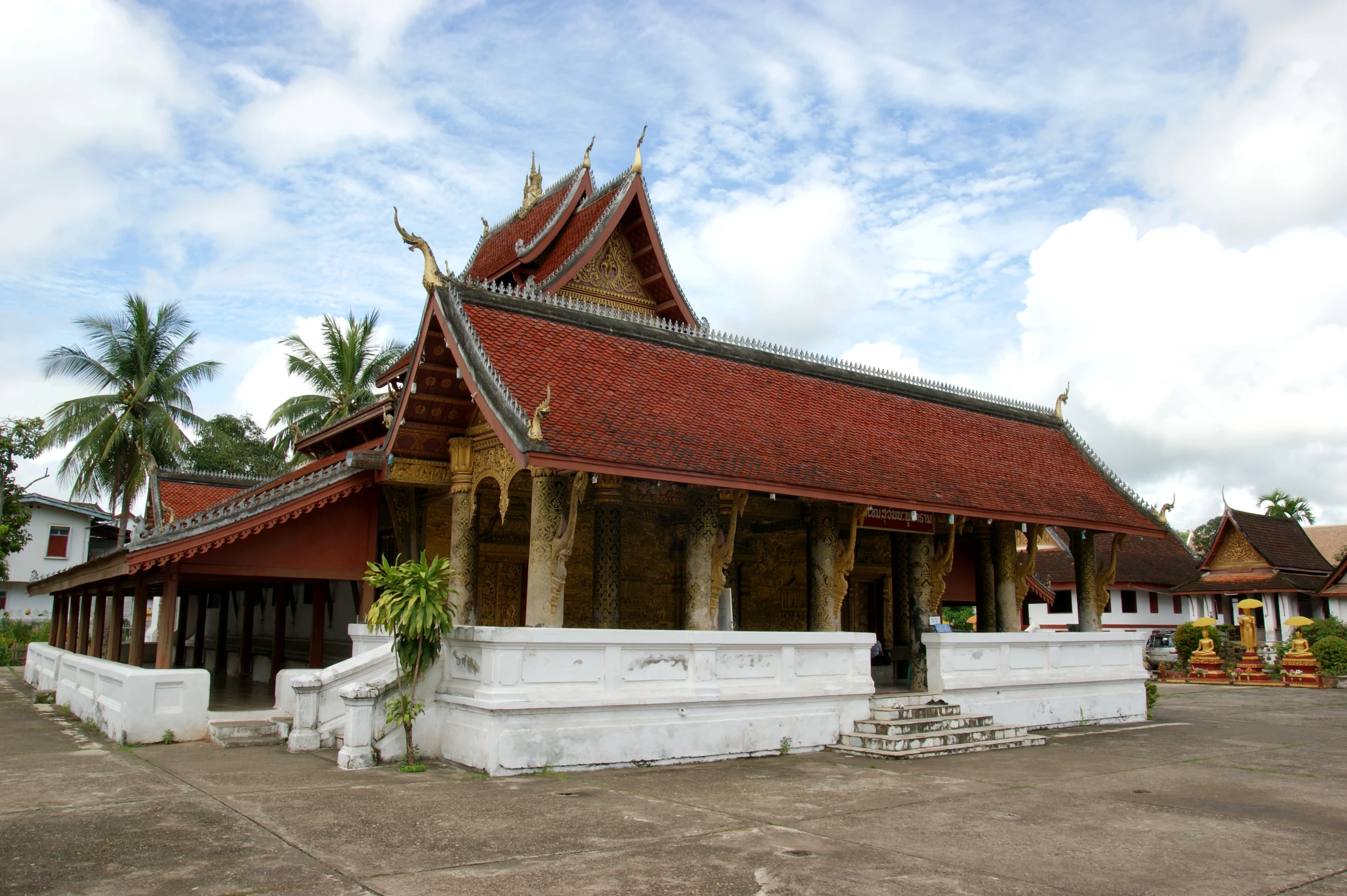 there is a building with a roof that is white and red