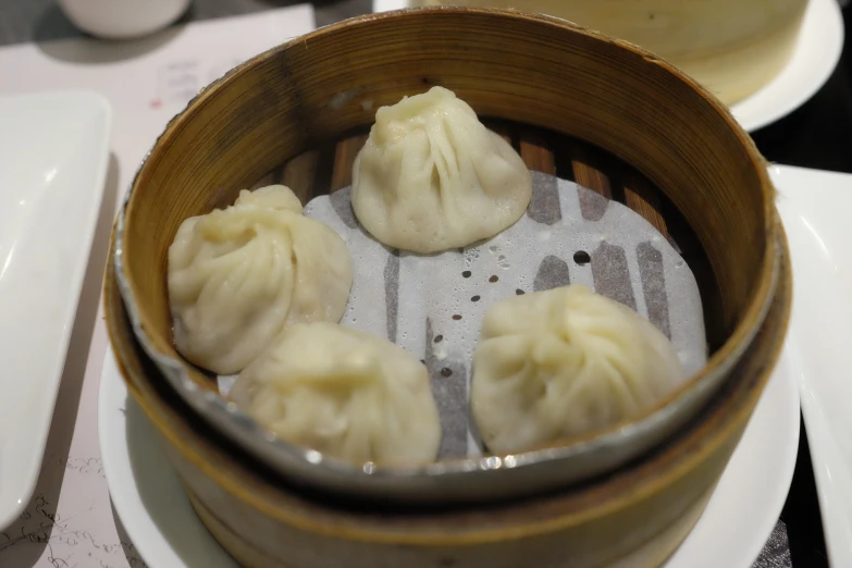 several dumplings are in a wooden bowl