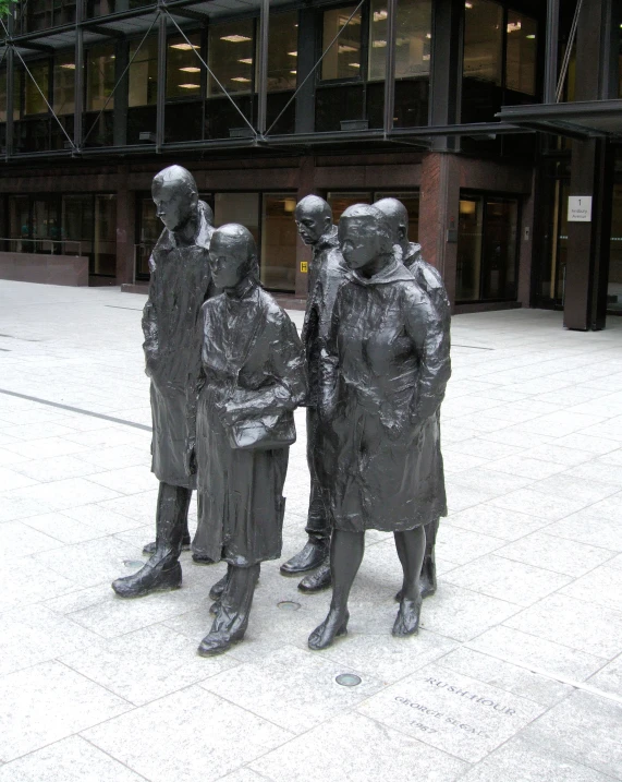 a metal statue is in front of some windows