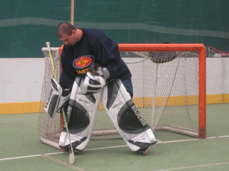 hockey goalie checking the markings on his gloves