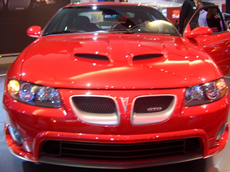 an orange sports car is on display at a showroom