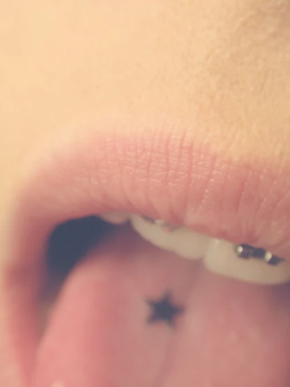 the tongue of a child with little black stars on it