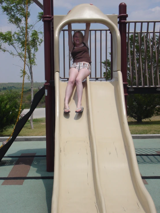 there is a girl that is playing in a slide