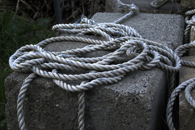 a rope is tied to top of a stone