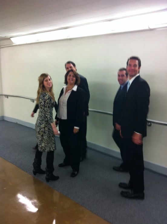 four people posing for a pograph in a building