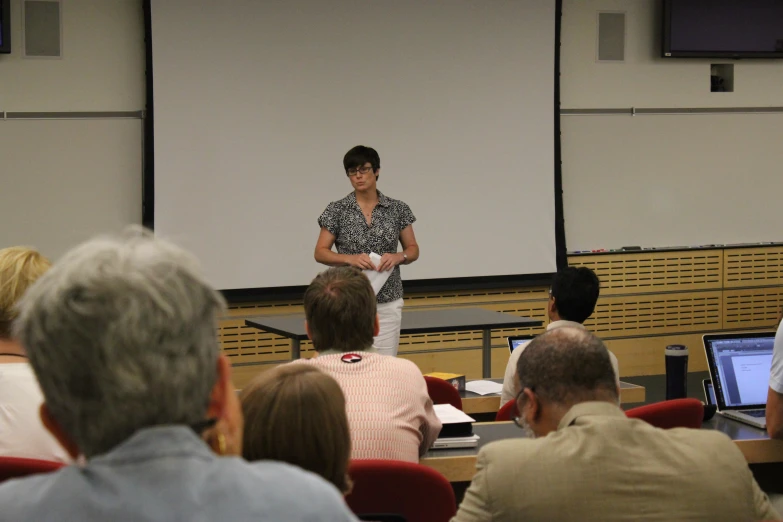 man speaking in front of a group of people