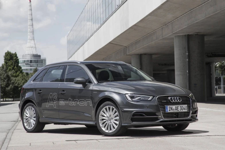 a grey audi q3 parked in front of a building