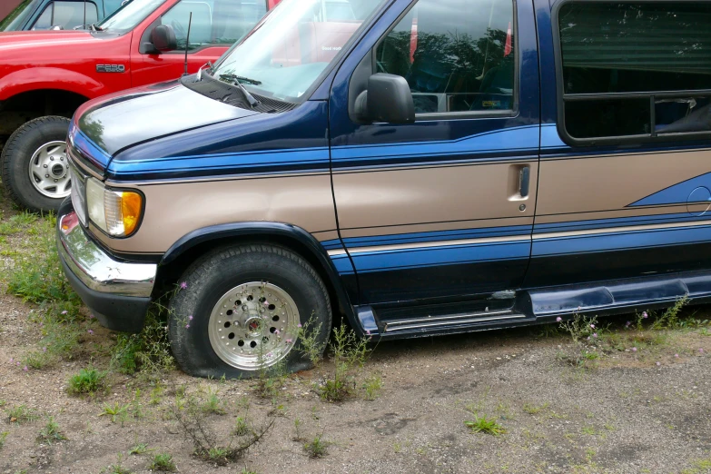 two vehicles parked next to each other in a lot