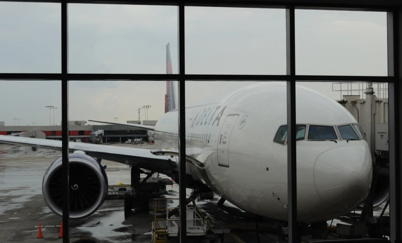 the reflection of a plane in an airport window