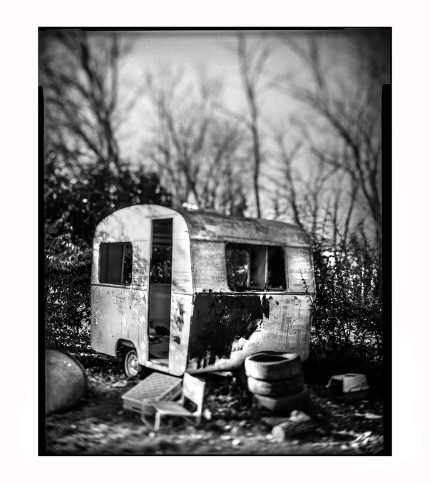 an old trailer with a broken chair in it