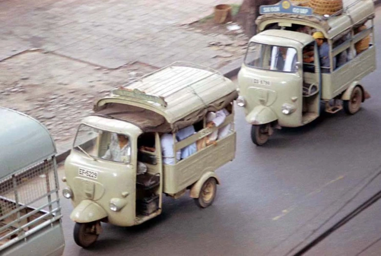 two vehicles going down the street, with no passenger