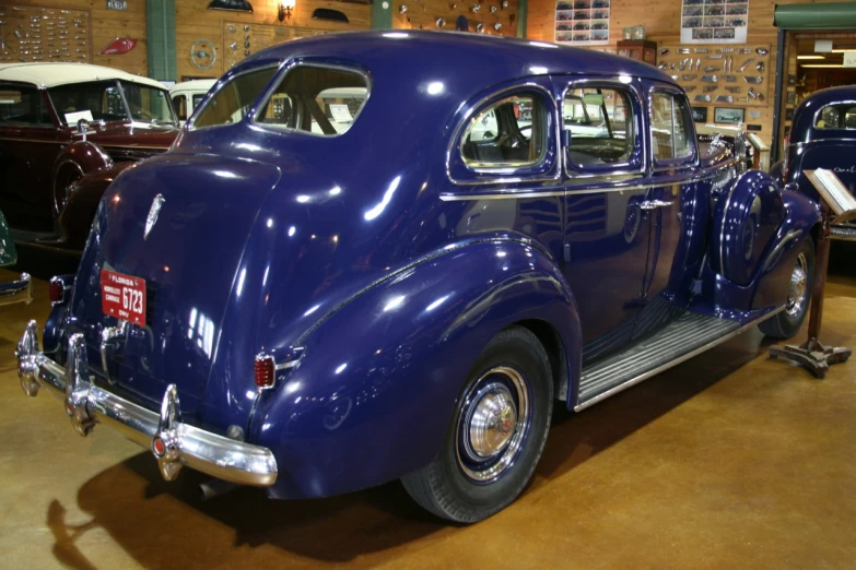 a close up of a purple car with other cars in the background