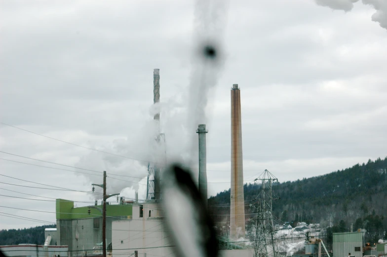 a smokestack with a steam billowing from it