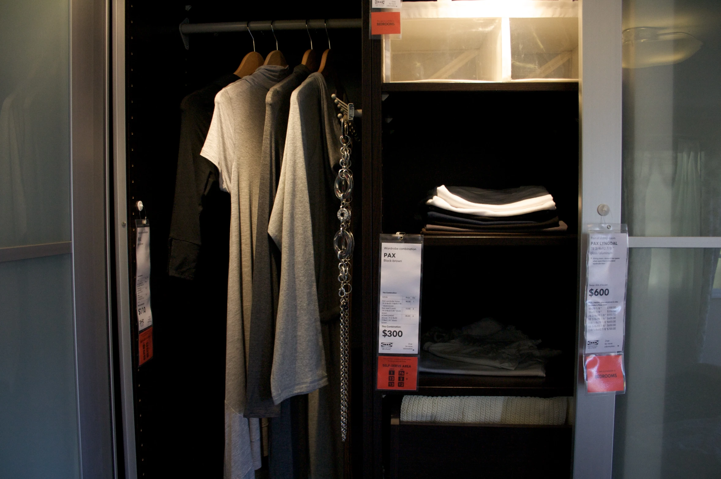 an empty closet with a shelf of clothes on it