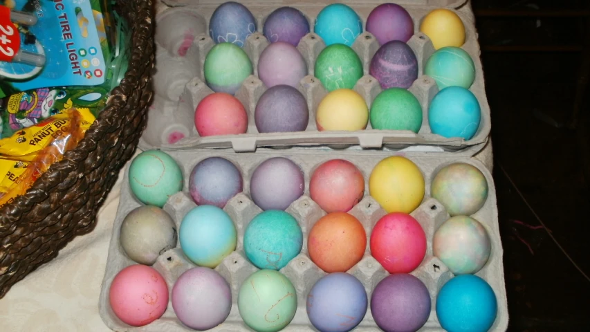 some eggs with different color sitting in a box