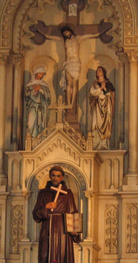 statue of a person wearing a crucifix