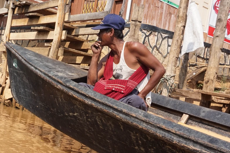 a man sitting in a boat on the water