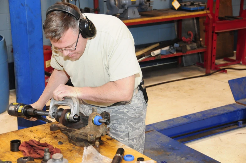 an engineer working in a garage with many tools