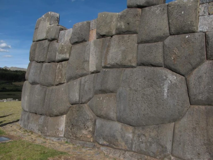 an old block of stone is used as a fence